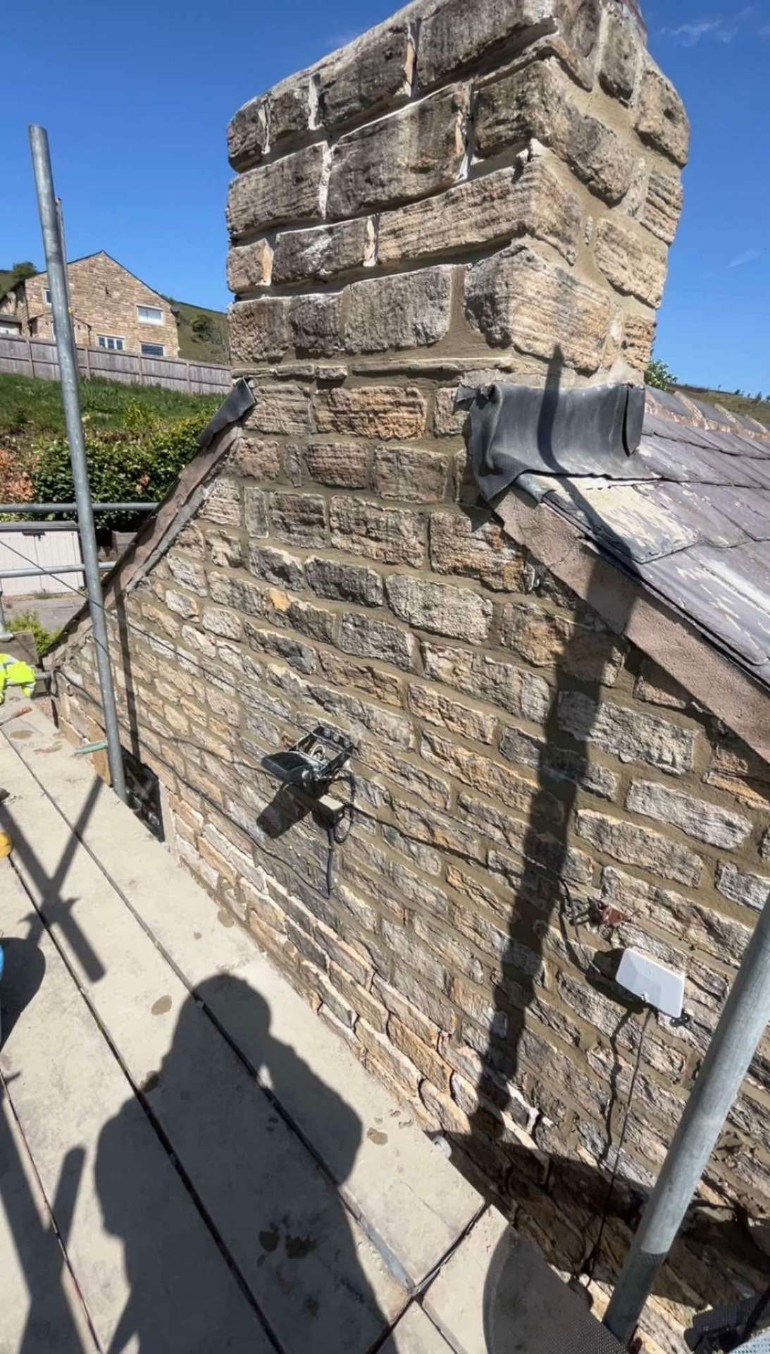 Stone chimney repointing in progress